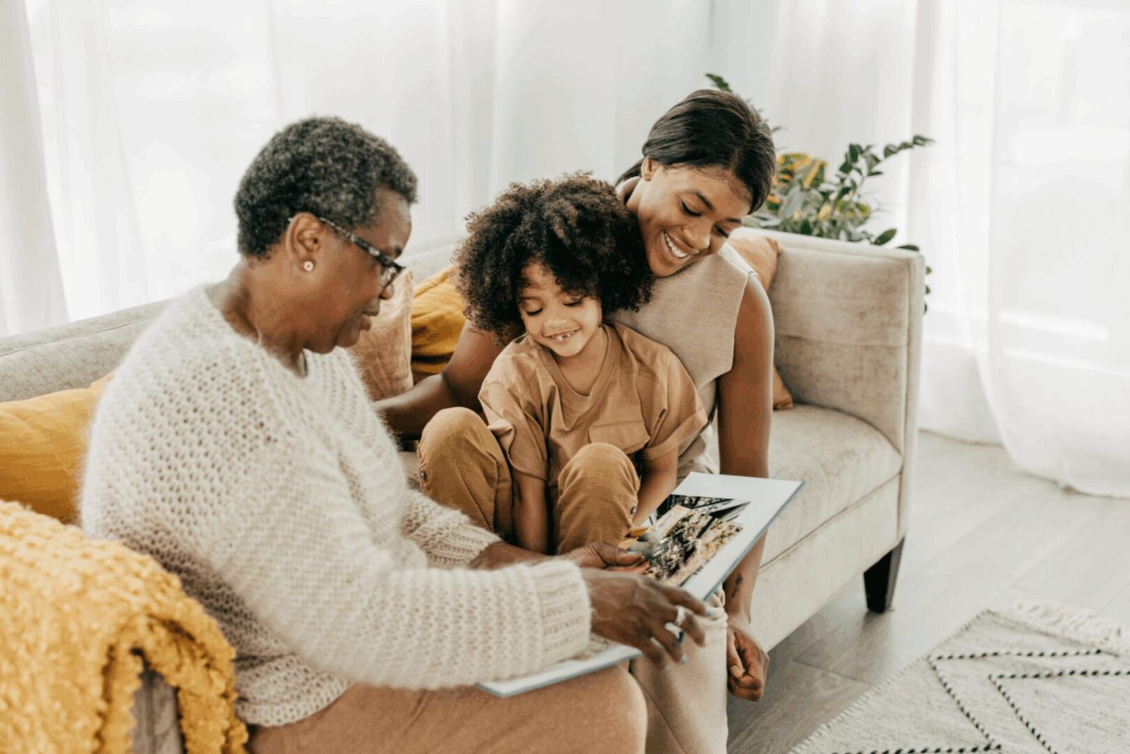 Three people looking at a photo album.